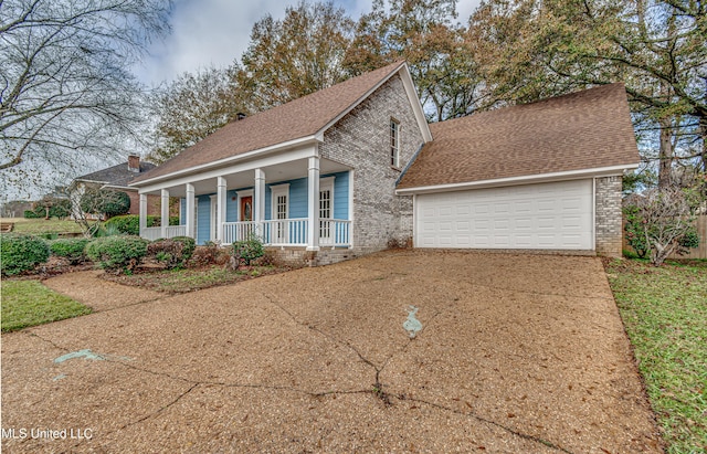 view of front of house with covered porch and a garage