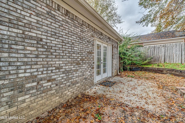 view of side of property featuring a patio area and french doors