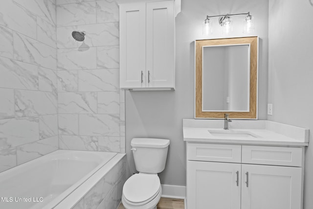 full bathroom featuring vanity, tiled shower / bath combo, and toilet