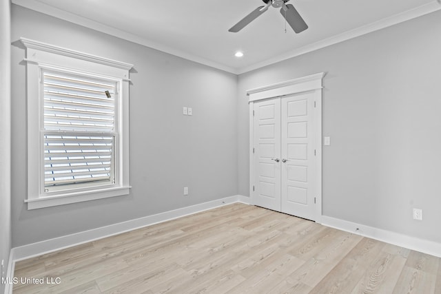 unfurnished bedroom with light hardwood / wood-style floors, ceiling fan, a closet, and crown molding