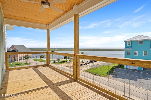 wooden terrace with ceiling fan and a water view