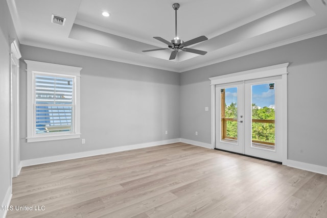 spare room featuring french doors, light hardwood / wood-style floors, ceiling fan, and crown molding