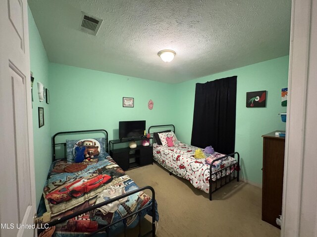 9831 Crooked Creek Blvd, Byram, MS 39272 - carpeted bedroom with a textured ceiling