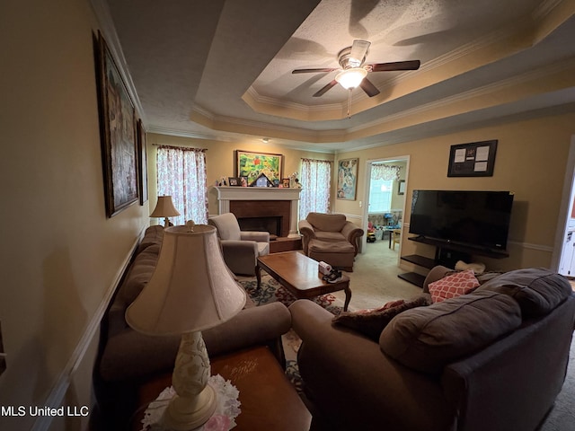 9831 Crooked Creek Blvd, Byram, MS 39272 - carpeted living area with a raised ceiling, ceiling fan, a brick fireplace, ornamental molding, and plenty of natural light