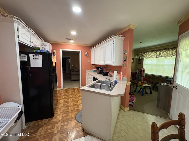 9831 Crooked Creek Blvd, Byram, MS 39272 - kitchen featuring freestanding refrigerator, a sink, a peninsula, ornamental molding, and white cabinets