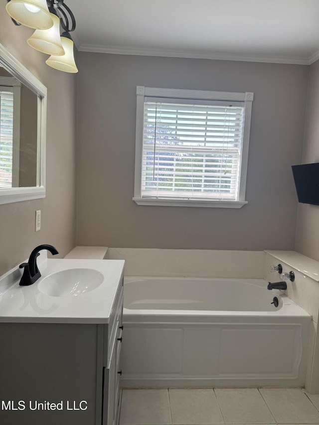 bathroom with crown molding, vanity, tile patterned flooring, and a garden tub