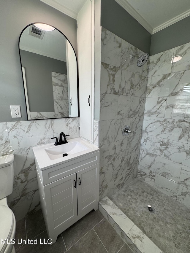 bathroom with visible vents, ornamental molding, vanity, toilet, and a tile shower