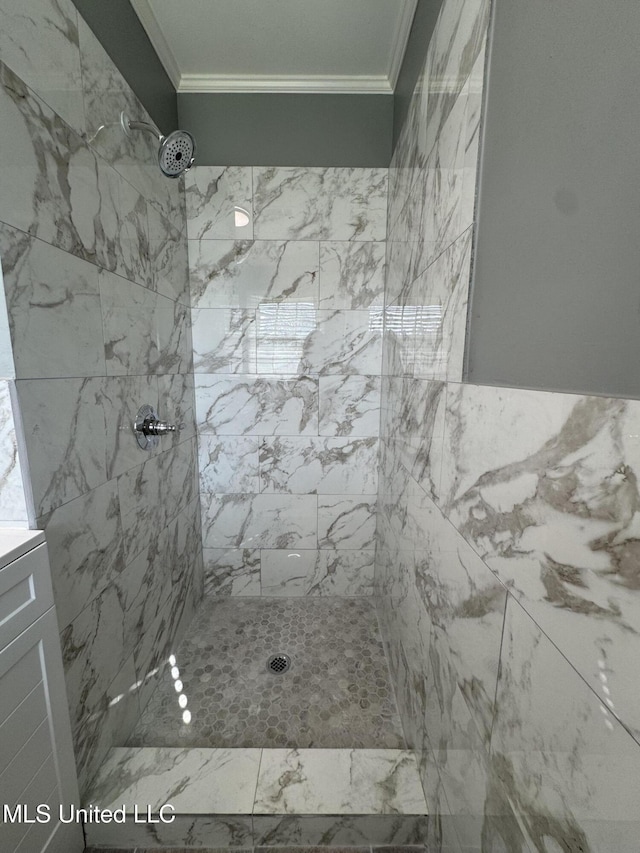 full bathroom featuring crown molding and tiled shower