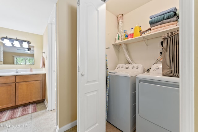 3230 Cumberand Rd Unit 56, Ocean Springs, MS 39564 - laundry area featuring washer and clothes dryer, light tile patterned floors, a ceiling fan, and baseboards