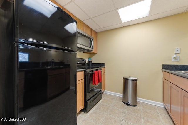3230 Cumberand Rd Unit 56, Ocean Springs, MS 39564 - kitchen with black appliances, dark countertops, a paneled ceiling, light tile patterned floors, and baseboards