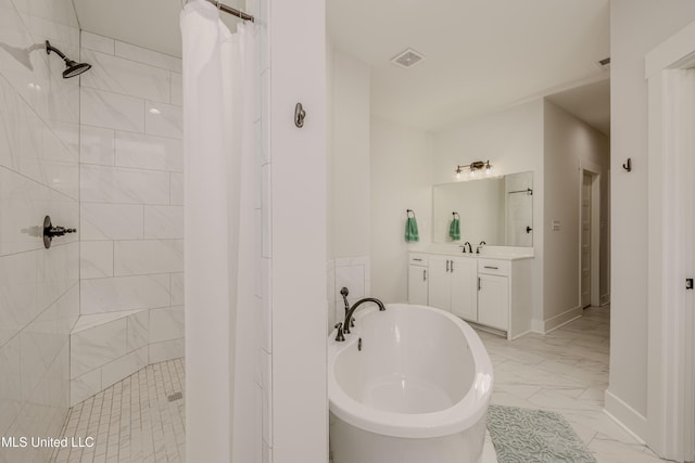 5267 Reserve Way, Hernando, MS 38632 - full bath with marble look tiles, a tile shower, a freestanding tub, vanity, and baseboards