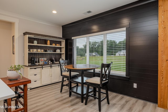 5267 Reserve Way, Hernando, MS 38632 - dining space with light wood-style flooring, crown molding, wooden walls, and recessed lighting
