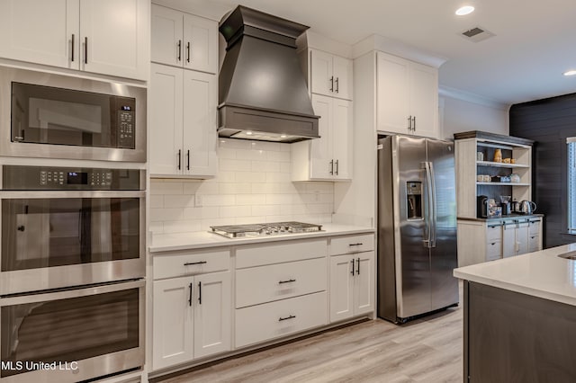 5267 Reserve Way, Hernando, MS 38632 - kitchen with appliances with stainless steel finishes, custom range hood, light countertops, open shelves, and recessed lighting