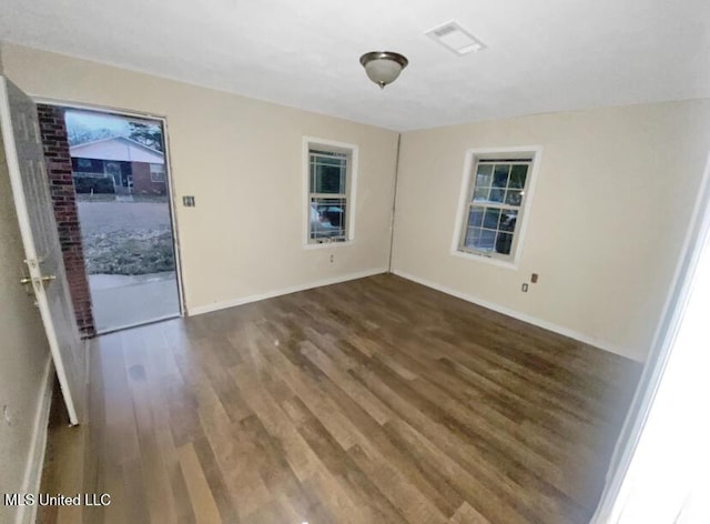 spare room featuring dark wood-type flooring