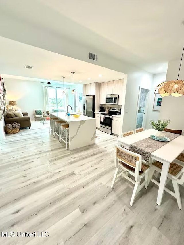 1302 Magnolia St Unit 202, Gulfport, MS 39507 - dining space with light wood finished floors and recessed lighting