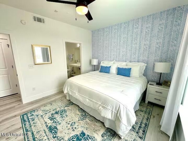 1302 Magnolia St Unit 202, Gulfport, MS 39507 - bedroom featuring light wood finished floors, ensuite bath, and ceiling fan