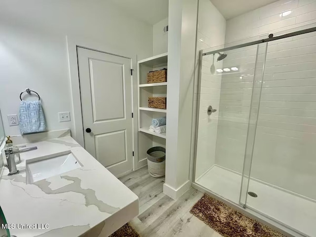 1302 Magnolia St Unit 202, Gulfport, MS 39507 - full bathroom featuring wood finished floors, a shower stall, and vanity