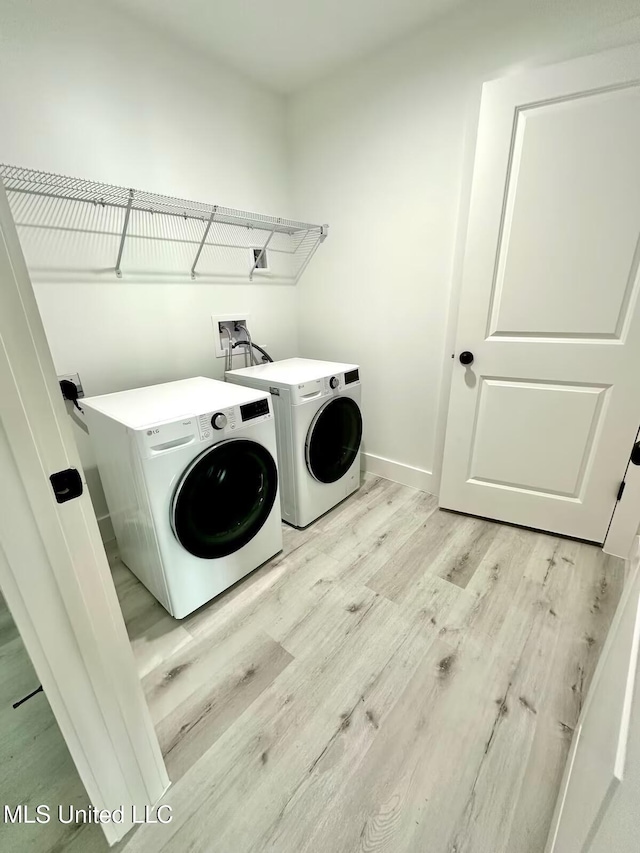 1302 Magnolia St Unit 202, Gulfport, MS 39507 - washroom with wood finished floors and independent washer and dryer