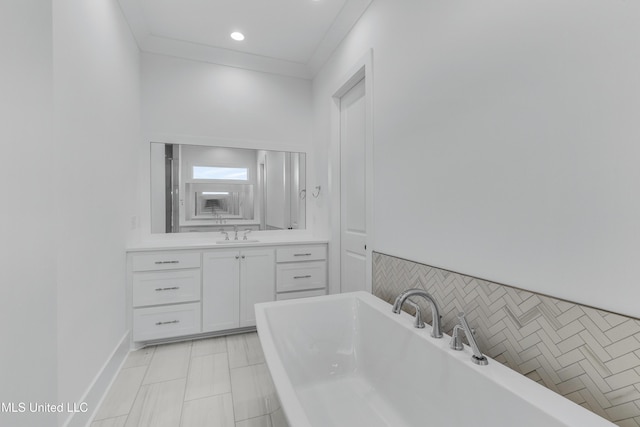 bathroom with ornamental molding, a soaking tub, vanity, and recessed lighting