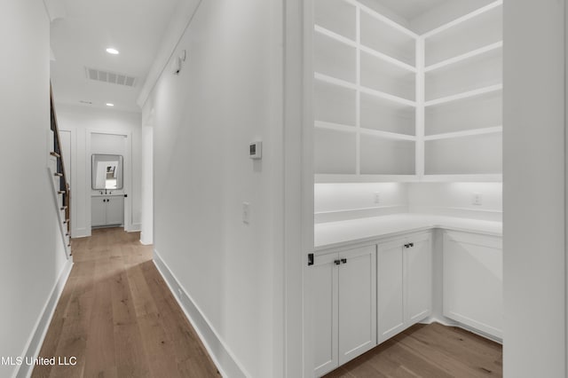 hall featuring recessed lighting, baseboards, visible vents, and light wood finished floors