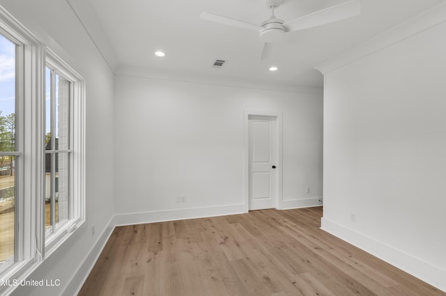 spare room featuring baseboards, ceiling fan, crown molding, light wood-type flooring, and recessed lighting