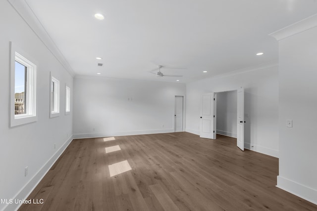 spare room with baseboards, dark wood-type flooring, recessed lighting, and crown molding