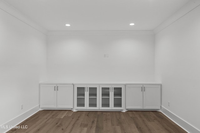 interior space with ornamental molding, recessed lighting, baseboards, and wood finished floors