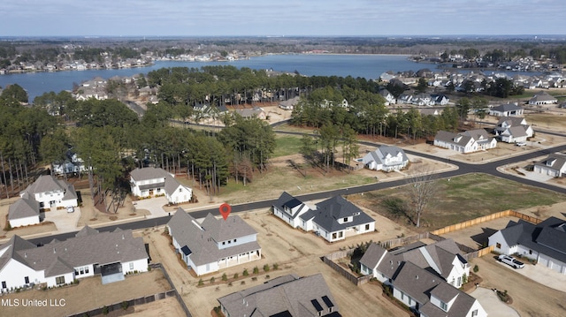 drone / aerial view with a water view and a residential view