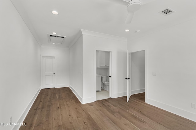 interior space featuring attic access, visible vents, and crown molding