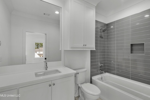 bathroom with toilet, bathing tub / shower combination, vanity, and visible vents