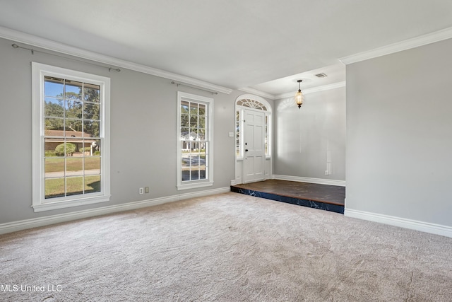 foyer entrance with ornamental molding and carpet floors