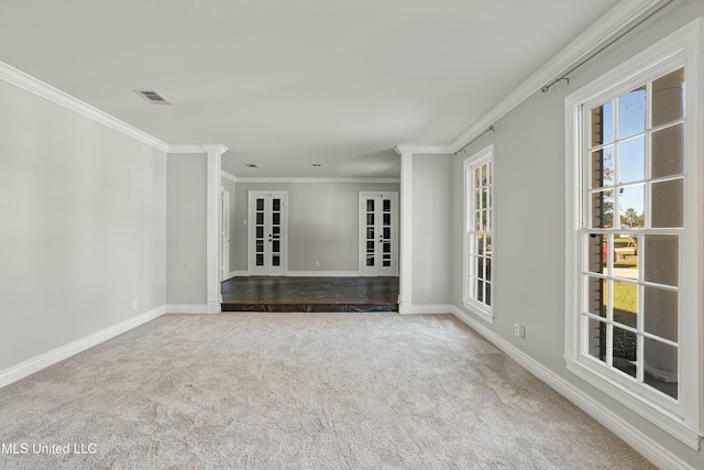 empty room with french doors, carpet, and ornamental molding