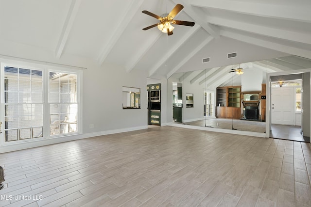 unfurnished living room featuring beam ceiling, ceiling fan, high vaulted ceiling, and light wood-type flooring