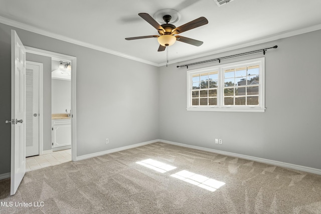 carpeted empty room featuring ceiling fan and ornamental molding