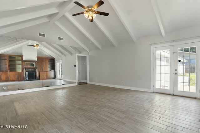 unfurnished living room with ceiling fan, french doors, beamed ceiling, and light hardwood / wood-style floors