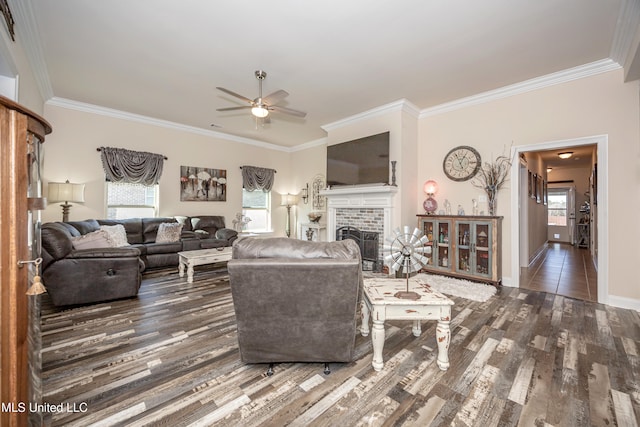 living room with dark hardwood / wood-style flooring, a brick fireplace, ceiling fan, and crown molding