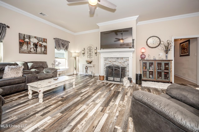 living room featuring hardwood / wood-style flooring, a brick fireplace, ceiling fan, and ornamental molding