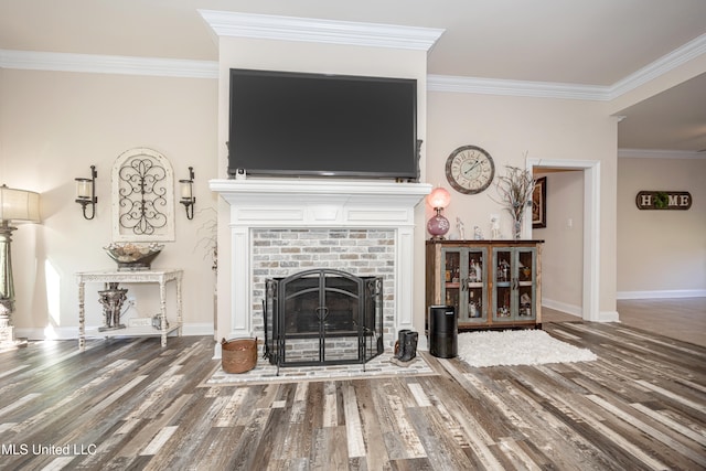 living room featuring crown molding, a fireplace, and hardwood / wood-style floors