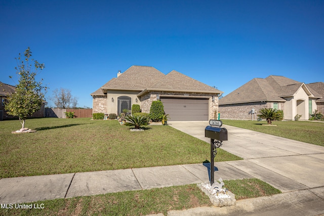 view of front of home featuring a front yard and a garage