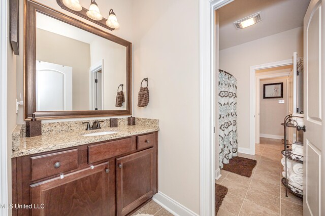 bathroom featuring tile patterned flooring and vanity