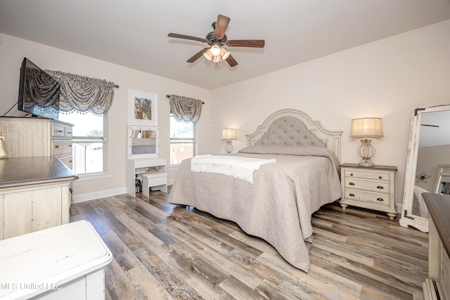 bedroom with ceiling fan and dark hardwood / wood-style flooring