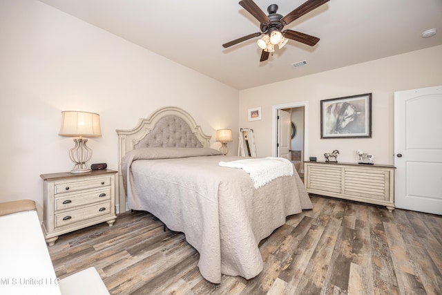 bedroom with ceiling fan and dark wood-type flooring