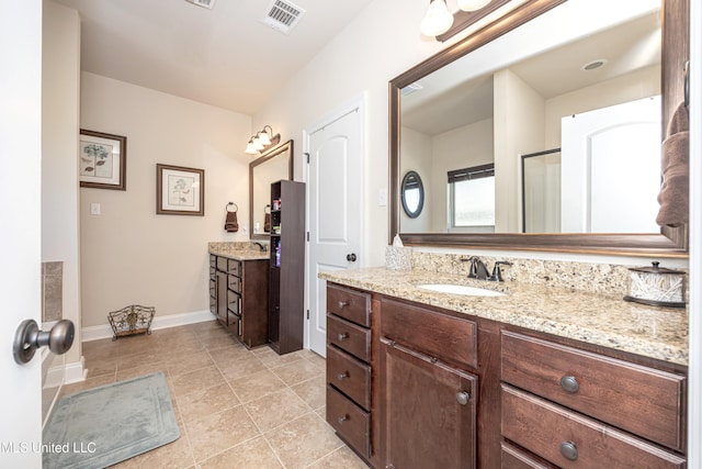 bathroom with tile patterned flooring and vanity