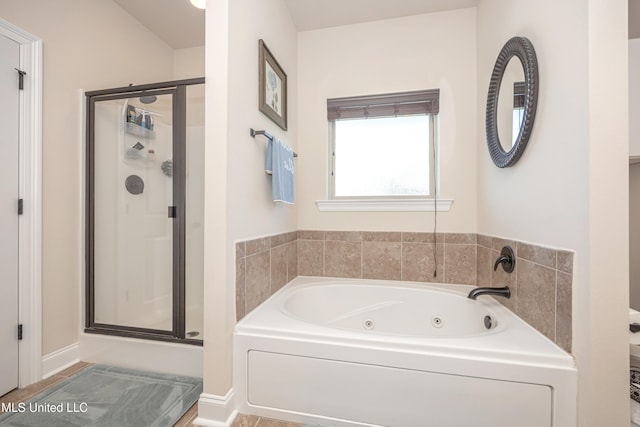 bathroom featuring independent shower and bath