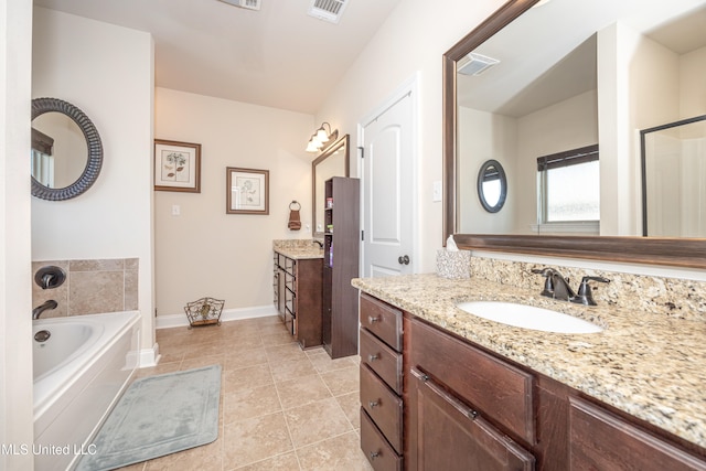 bathroom featuring tile patterned flooring, vanity, and a bath