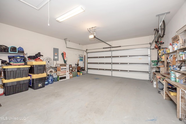 garage featuring electric panel and a garage door opener