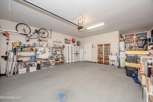 garage with a workshop area and a garage door opener