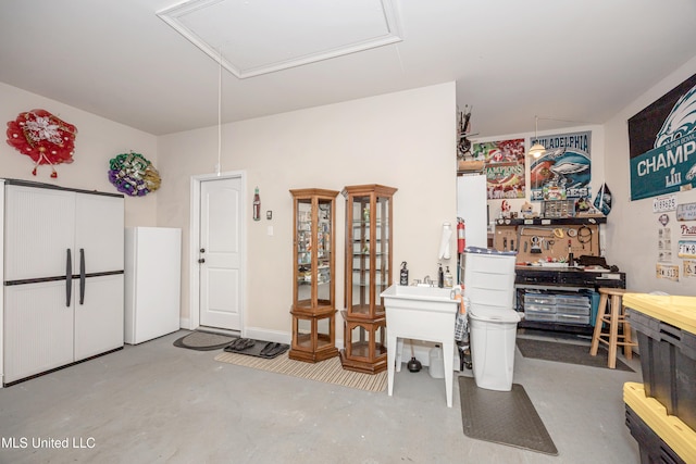 miscellaneous room featuring a workshop area and sink