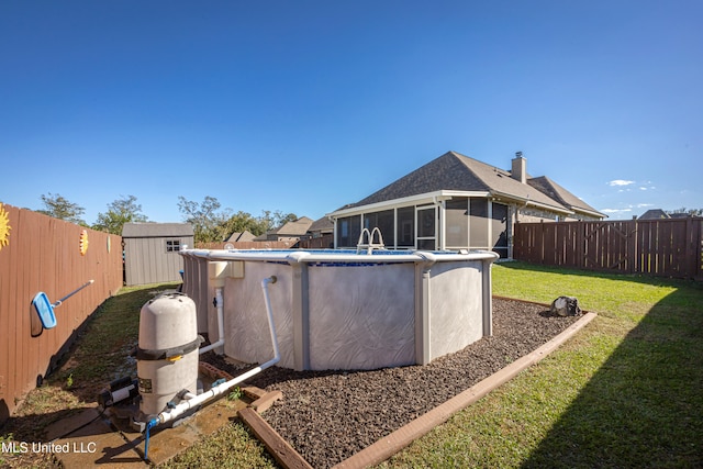 back of house with a sunroom, a fenced in pool, a lawn, and a storage shed