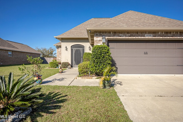 view of front of home with a garage and a front yard